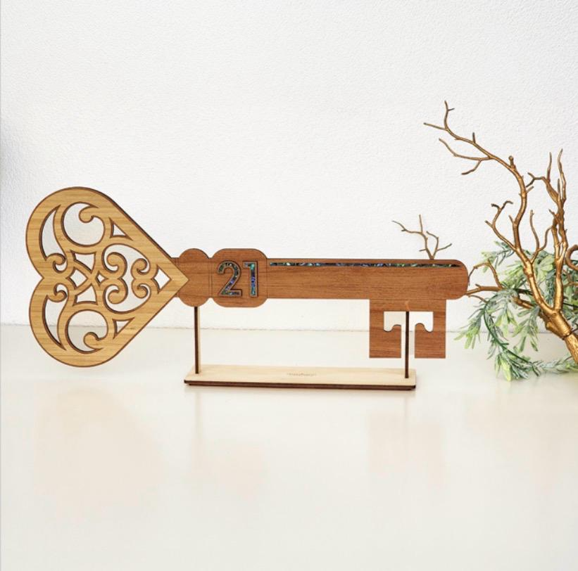 Filigree heart timber 21st birthday key with paua shell 21 numerals on timber display stand