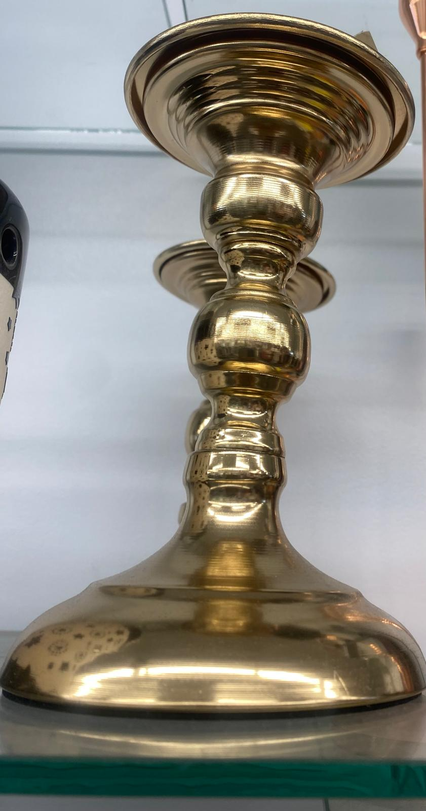 Classic polished brass candlestick holder with turned bobbin stem and wide flared base