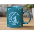 Teal ceramic mug with white Celtic crescent moon hare and stars design