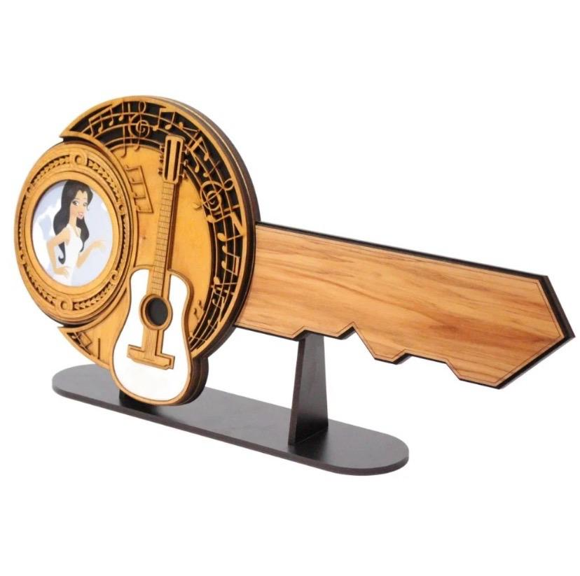 Music-themed timber 21st birthday key with guitar and musical notes on black metal display stand