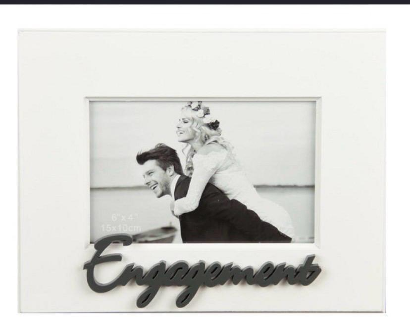 White engagement photo frame with 3D dark script Engagement lettering at base